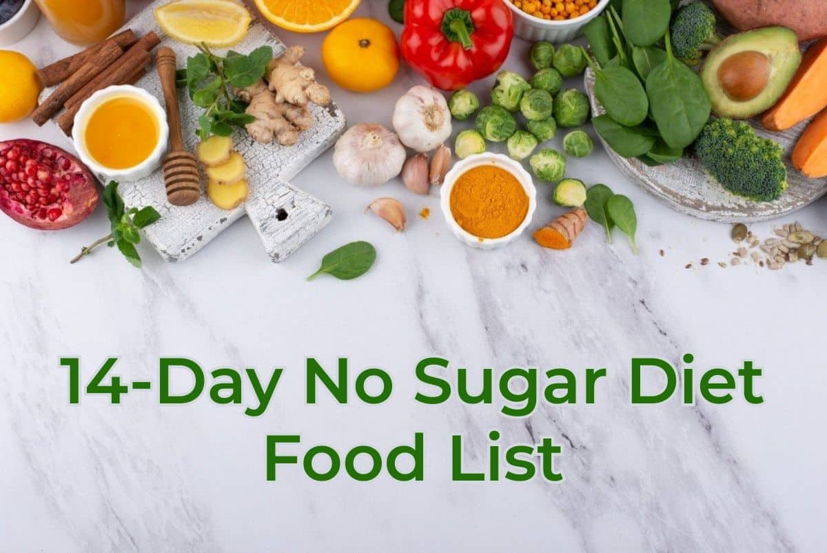 A flat lay image of various healthy foods on a white marble background. The foods include honey, ginger, turmeric, garlic, spinach, brussels sprouts, avocados, sweet potatoes, red pepper, pomegranate, and various herbs and spices. The text "14-Day No Sugar Diet Food List" is written in green at the bottom of the image.