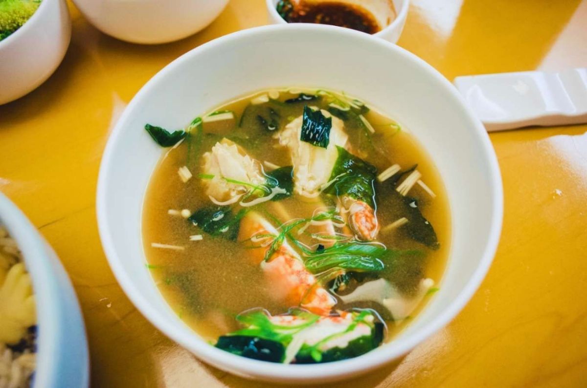 A bowl of miso soup with seaweed, tofu, and green onions, answering the question: is miso soup vegan?