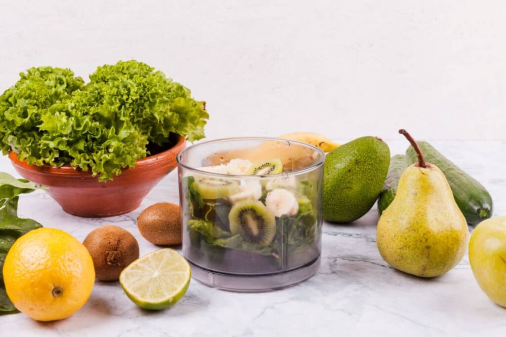 Fresh fruits and vegetables, including lettuce, kiwi, pear, lime, lemon, and avocado, arranged on a kitchen counter. Does Vitamin Water have caffeine? Ingredients of Vitamin Water.