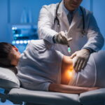 Stem Cell Therapy for Back Pain Doctor administering a stem cell injection into the lower back of a patient lying on a treatment bed in a modern medical clinic.