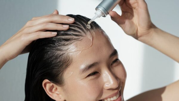 Scalp Detox A Smiling Person Applies Serum Or Oil To Their Scalp With A Dropper, Massaging It Into Wet Hair.