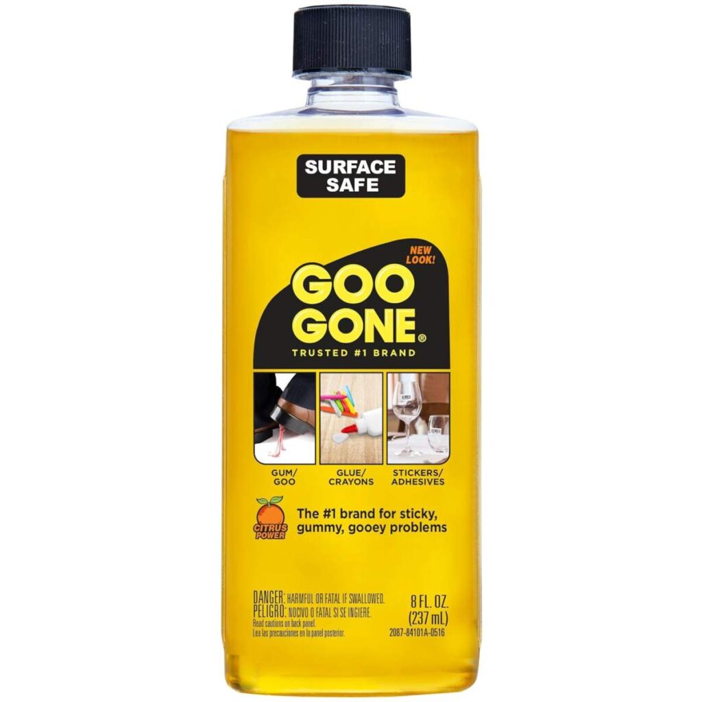 A Bottle Of Goo Gone Original Adhesive Remover With A Yellow Label, Placed On A White Background.