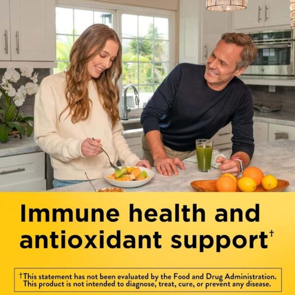 Two People At A Kitchen Counter With Fresh Fruits And A Green Smoothie, With A Health-Related Ad Claim.