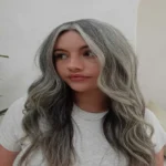 Grey Hair Blending Is Becoming the Go-To Beauty Trend for a Softer, Younger Look 5 A Close-Up Studio Portrait Of A Woman Showcasing A Beautifully Styled, Layered Short Pixie Cut With Multi-Tonal Silver And Grey Hair Strands.