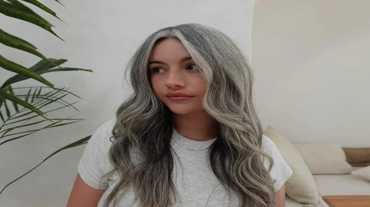 Grey Hair Blending Is Becoming the Go-To Beauty Trend for a Softer, Younger Look 1 A Close-Up Studio Portrait Of A Woman Showcasing A Beautifully Styled, Layered Short Pixie Cut With Multi-Tonal Silver And Grey Hair Strands.